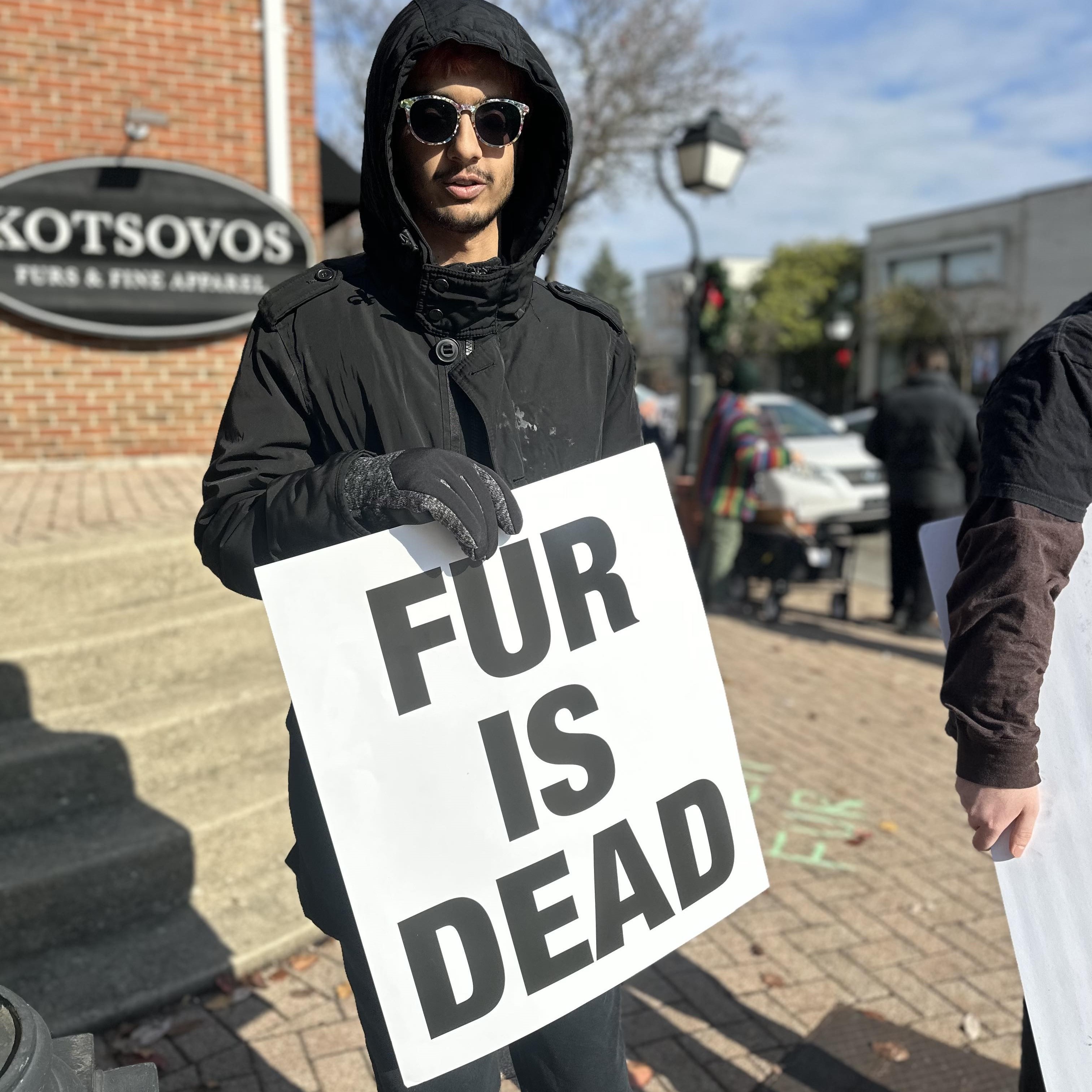 Aashish with a sign that says 'Fur is dead'