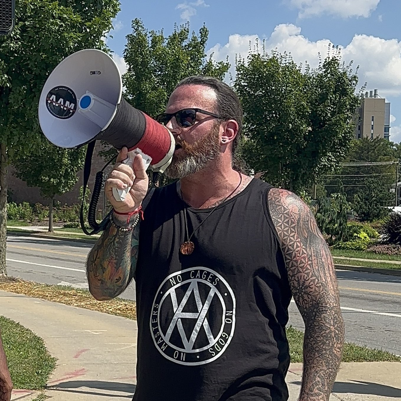 Adam at Ohio Occurrence speaking into a megaphone