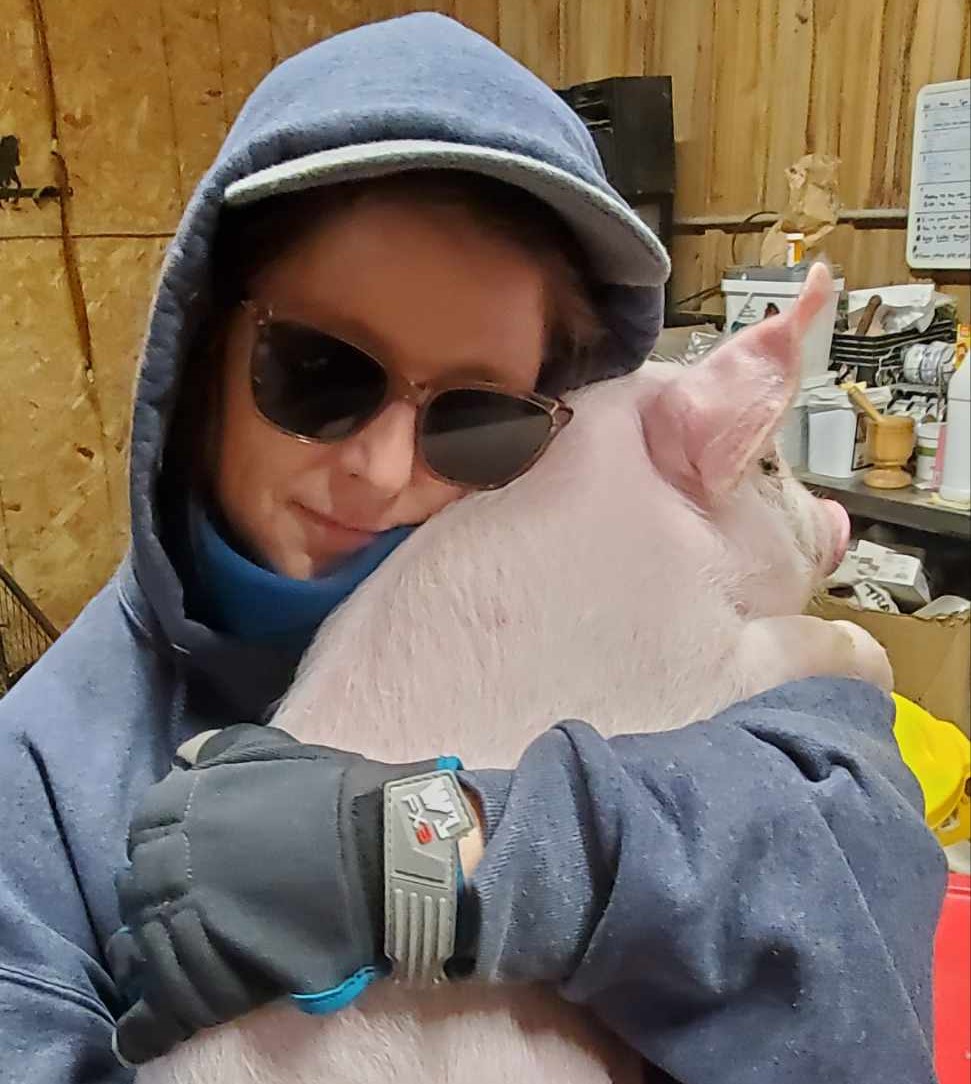 Sabrina holding a pig